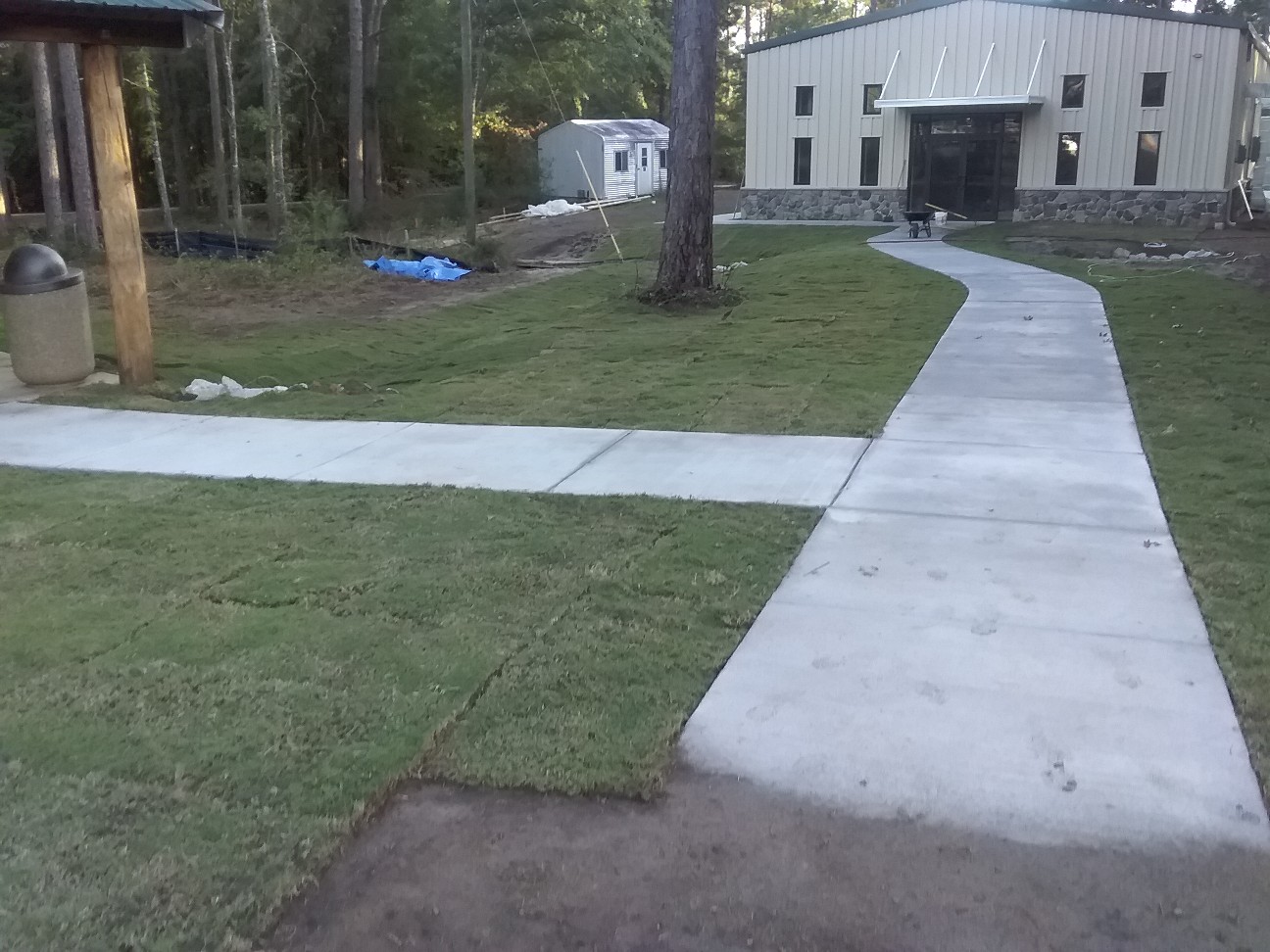 Sod and concrete walkways around a building.